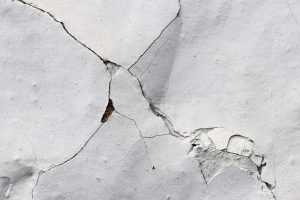Cracked white plaster wall